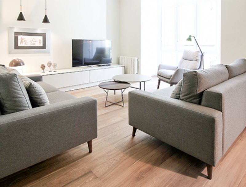 living room by estudio pas with grey sofas