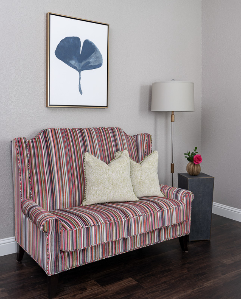 Nicole Arnold: Sofa Design, A living room with a colorful striped sofa.