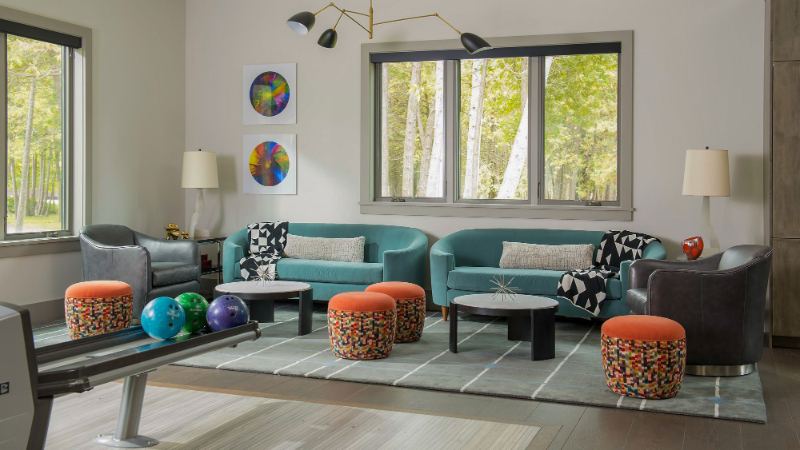 Arveaux Interiors: Modern Sofa Inspiration. A colourful living room with two blue sofas, two armchairs, and four  colorful upholstered stools.
